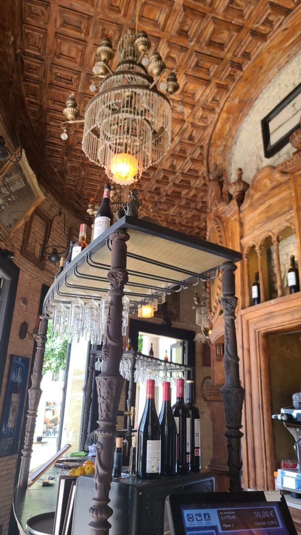 Ornately decorated ceiling of El Gallo Azul, showcasing intricate designs and the establishment's rich artistic heritage