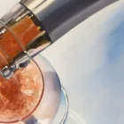 Intricate detail showcasing the texture and depth of acrylic pouring in a champagne-themed painting