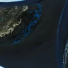 Detailed view of acrylic pour technique on a Sherry wine bottle painting, showcasing intricate patterns and textures.