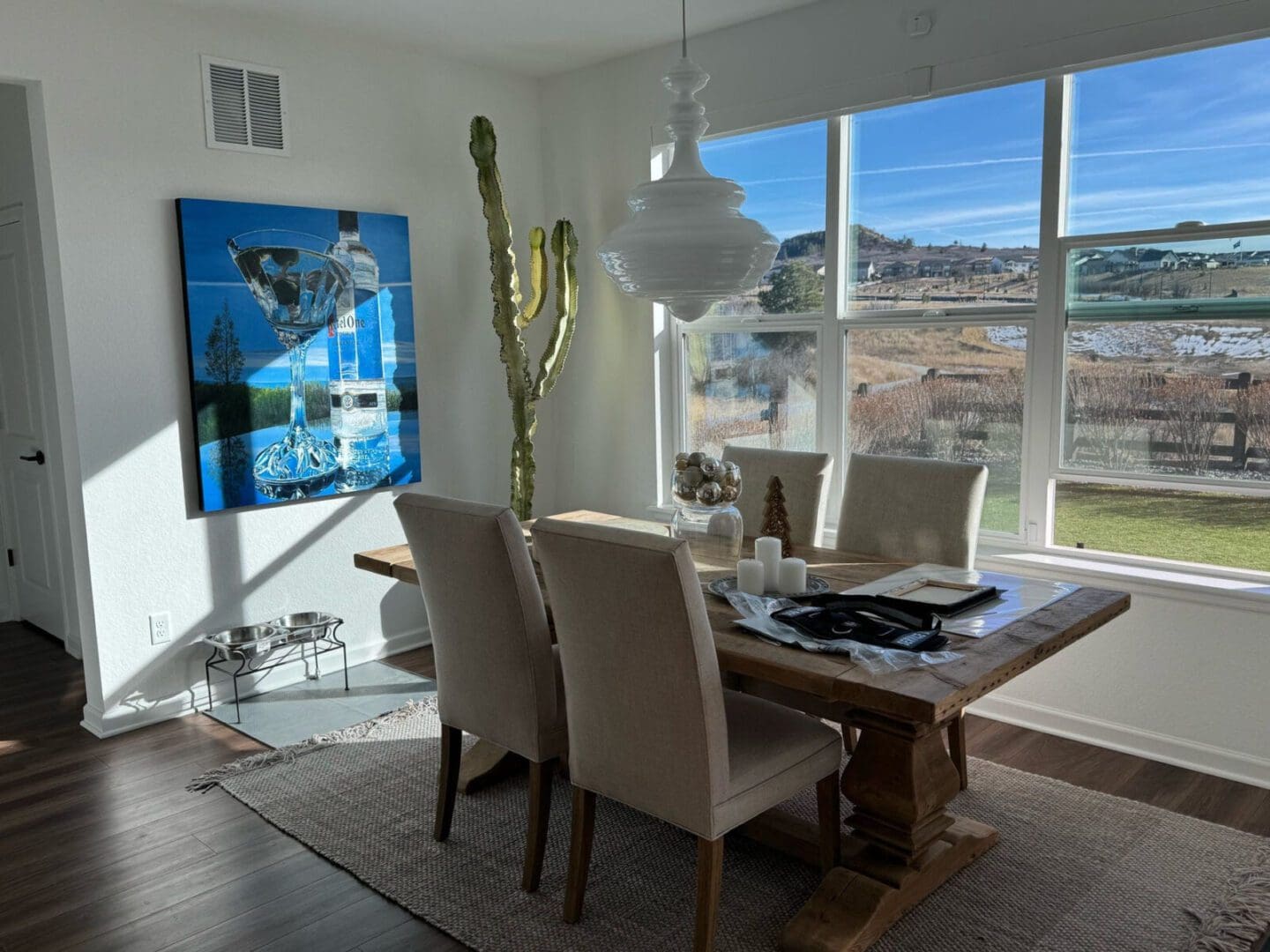 A custom commissioned painting adorns a dining room wall, its vibrant colors adding warmth and elegance to the space.