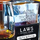 Artistic close-up showcasing the dynamic acrylic pouring technique used to represent LAWS Whiskey.