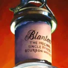 depiction of a Blanton's bourbon bottle top with a horse and jockey.