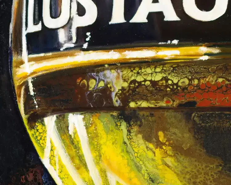 Close-up of a painted Lustau sherry glass with vibrant acrylic details and precise lettering against a dark backdrop