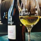 Painting of Lustau sherry bottle and glass on table capturing the essence of Jerez winemaking.